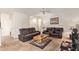 Spacious living room with plush seating, neutral carpeting, and a ceiling fan at 2734 W Bowker St, Phoenix, AZ 85041