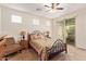Bright main bedroom with a ceiling fan, warm lighting, and access to the backyard at 2734 W Bowker St, Phoenix, AZ 85041