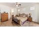 Comfortable main bedroom with a ceiling fan, carpet flooring, and an ensuite bathroom at 2734 W Bowker St, Phoenix, AZ 85041