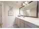 Elegant bathroom features a white vanity and framed art at 29966 N 72Nd Dr, Peoria, AZ 85383