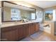 Bathroom featuring double vanity, soaking tub, and bright window at 29966 N 72Nd Dr, Peoria, AZ 85383