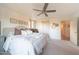 Inviting primary bedroom with a ceiling fan and sliding barn door at 29966 N 72Nd Dr, Peoria, AZ 85383