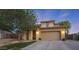 Charming exterior features a well-manicured lawn, an attached garage, and a covered entryway at 29966 N 72Nd Dr, Peoria, AZ 85383