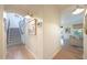 Bright and airy hallway with hardwood floors that leads to the staircase and other rooms at 29966 N 72Nd Dr, Peoria, AZ 85383