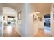Well-lit hallway with hardwood floors leading to the dining area and other rooms at 29966 N 72Nd Dr, Peoria, AZ 85383