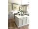 Beautiful kitchen with a large island, white cabinets, stainless steel appliances, and modern lighting at 29966 N 72Nd Dr, Peoria, AZ 85383