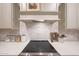 Close-up of the kitchen's smooth cooktop and marble backsplash at 29966 N 72Nd Dr, Peoria, AZ 85383