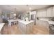 Open-concept kitchen and dining area with an island, stainless steel appliances, and a view into the living area at 29966 N 72Nd Dr, Peoria, AZ 85383