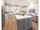 Modern kitchen featuring white cabinets, stainless steel appliances, and a large island at 29966 N 72Nd Dr, Peoria, AZ 85383