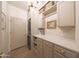 Well-organized laundry room featuring counter space, cabinetry, and a front-load washer and dryer at 29966 N 72Nd Dr, Peoria, AZ 85383