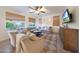 Cozy living room featuring an oversized sectional sofa, ceiling fan, and natural light at 29966 N 72Nd Dr, Peoria, AZ 85383