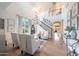 Bright living room with large windows, hardwood floors, and staircase at 29966 N 72Nd Dr, Peoria, AZ 85383