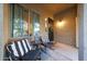 Cozy covered patio with chairs and a side table, offering a relaxing outdoor space with a view to the yard at 29966 N 72Nd Dr, Peoria, AZ 85383
