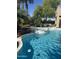 A luxurious pool and spa offer a relaxing backyard oasis with lush tropical landscaping at 29966 N 72Nd Dr, Peoria, AZ 85383