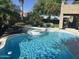 Backyard swimming pool and spa surrounded by lush landscaping and seating area with patio furniture at 29966 N 72Nd Dr, Peoria, AZ 85383