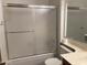 This bathroom offers a shower with sliding glass doors, a sink with a vanity, and a toilet with a paper holder at 314 E Campo Bello Dr, Phoenix, AZ 85022