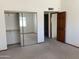 This bedroom features closet with mirrored doors, neutral carpet, and an open door to a private bathroom at 314 E Campo Bello Dr, Phoenix, AZ 85022