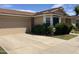 Single-story home with a two-car garage, driveway, and lovely green lawn at 314 E Campo Bello Dr, Phoenix, AZ 85022