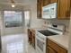 Cozy eat-in kitchen with tiled floor, wooden cabinets, and modern appliances at 314 E Campo Bello Dr, Phoenix, AZ 85022