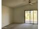 Carpeted living room with ceiling fan and sliding glass door to the backyard at 314 E Campo Bello Dr, Phoenix, AZ 85022