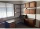 This office features a long desk with built-in drawers, cabinets, shelves, and a view from the window at 314 E Campo Bello Dr, Phoenix, AZ 85022