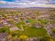 Residential area featuring a verdant neighborhood park with playground, basketball court, and walking path at 31900 N 127Th Ln, Peoria, AZ 85383