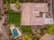 Expansive backyard featuring a pool, lush lawn, and patio seating under a well-maintained tiled roof at 31900 N 127Th Ln, Peoria, AZ 85383