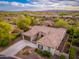 Stunning aerial view showcases the tiled roof, desert landscape, and extended driveway of the home at 31900 N 127Th Ln, Peoria, AZ 85383