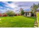 Spacious backyard featuring lush lawn and mature landscaping, offering a serene and private outdoor space at 31900 N 127Th Ln, Peoria, AZ 85383