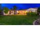 Lush backyard showcasing green grass, covered patio and desert landscaping at 31900 N 127Th Ln, Peoria, AZ 85383