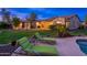 Inviting backyard oasis with lush lawn, pool, spa, lounge chairs, and desert landscaping at 31900 N 127Th Ln, Peoria, AZ 85383