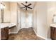 Bathroom with separate vanities, tile flooring, and neutral color scheme at 31900 N 127Th Ln, Peoria, AZ 85383