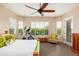 Well-lit bedroom featuring large windows and comfortable seating area at 31900 N 127Th Ln, Peoria, AZ 85383
