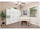 Bedroom with neutral walls featuring built in storage and a desk with natural light at 31900 N 127Th Ln, Peoria, AZ 85383