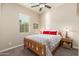 Cozy bedroom with a wooden bed frame, bedside tables, and carpeted floors at 31900 N 127Th Ln, Peoria, AZ 85383