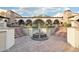 Picturesque courtyard with a central fountain, brick pathways, and arched colonnades at 31900 N 127Th Ln, Peoria, AZ 85383