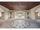 Elegant entryway showcasing a decorative mosaic floor, arched openings, and potted plants at 31900 N 127Th Ln, Peoria, AZ 85383