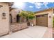 Inviting front entrance with stone accents, a well-manicured lawn, and a two-car garage at 31900 N 127Th Ln, Peoria, AZ 85383