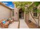 Welcoming front entrance with stone archway, desert landscaping, and cozy seating at 31900 N 127Th Ln, Peoria, AZ 85383
