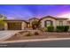 Charming exterior view with desert landscaping and stone accents with a tile roof at 31900 N 127Th Ln, Peoria, AZ 85383