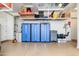 Well-organized garage featuring storage cabinets and hanging racks for tools and equipment at 31900 N 127Th Ln, Peoria, AZ 85383