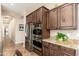 Modern kitchen featuring stainless steel appliances, granite countertops, and wooden cabinetry at 31900 N 127Th Ln, Peoria, AZ 85383