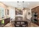 Gourmet kitchen with granite countertops, stainless steel appliances, and a large center island with seating at 31900 N 127Th Ln, Peoria, AZ 85383