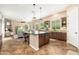 Spacious kitchen featuring an island and open floor plan into the living area with a fireplace at 31900 N 127Th Ln, Peoria, AZ 85383
