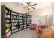 Cozy library with built-in bookshelves, comfortable seating, and a ceiling fan for added comfort at 31900 N 127Th Ln, Peoria, AZ 85383