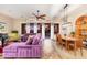 Open-concept living space with a dining area, ample seating, and large windows overlooking the backyard at 31900 N 127Th Ln, Peoria, AZ 85383