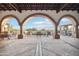 Inviting outdoor patio featuring stone arches, comfortable seating, and views of the Arizona landscape at 31900 N 127Th Ln, Peoria, AZ 85383