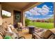 Inviting outdoor patio with comfortable seating and a fire pit, perfect for relaxing and entertaining at 31900 N 127Th Ln, Peoria, AZ 85383