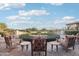 Relaxing outdoor patio with comfortable chairs, scenic views, and lush greenery at 31900 N 127Th Ln, Peoria, AZ 85383