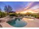 Resort-style pool and spa area with desert landscaping and lounge chairs under a colorful sunset sky at 31900 N 127Th Ln, Peoria, AZ 85383